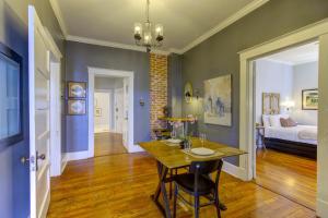 a dining room with a table and a bedroom at Elegant Colonial with Lovely Details and Character in Memphis