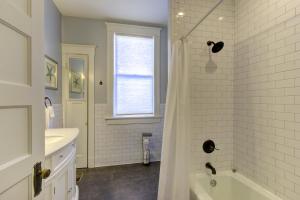 a white bathroom with a tub and a sink at Elegant Colonial with Lovely Details and Character in Memphis +24 photos