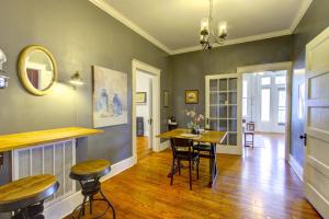 a living room with a table and chairs in it at Elegant Colonial with Lovely Details and Character in Memphis