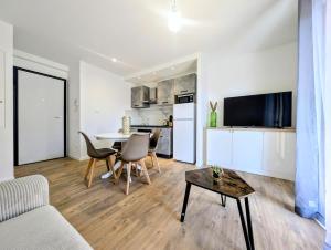 a living room with a table and a kitchen at La Régalide 2 B in Roquebrune-Cap-Martin +3 photos