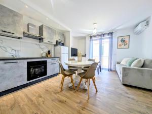 a kitchen and living room with a table and chairs at La Régalide 2 B in Roquebrune-Cap-Martin