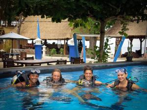 a group of people in a swimming pool at Blue Marine Resort in Gili Air