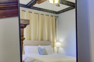 a mirror reflecting a bed in a bedroom at Classic Woodwork and Details in 1912 Colonial in Memphis
