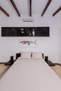 Кровать или кровати в номере Café de Playa Beach Front Hotel