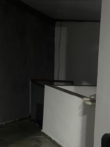 a room with a white wall and a white refrigerator at Paradise in Natal