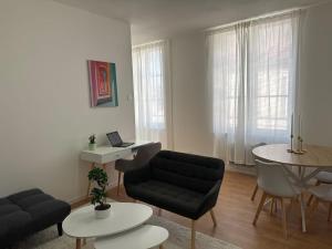 a living room with a couch and a table at Appartement Voltaire in Romilly-sur-Seine