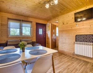 a dining room with a table and chairs at Domki u Henia i Anety in Werlas