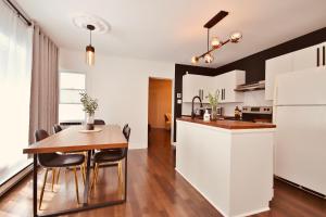 a kitchen and dining room with a table and chairs at Laurier Suites in Gatineau +17 photos