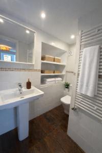 a bathroom with a sink and a toilet and a mirror at Casa en Vilallobent Cerdanya ideal familias by CalQuerol in Vilallovent +18 photos