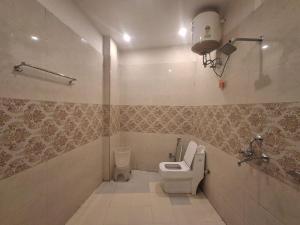 a bathroom with a toilet and a sink in it at The Four Season Pranav Resort - A Lavish Luxury Property in Nainital