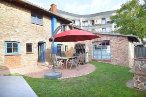 a patio with a table and chairs and an umbrella at Blankenese in Ahlbeck