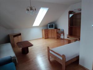 a room with a bed and a table and a tv at Wohnen mit Panoramablick in Gramastetten