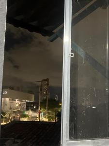 a window with a view of a city at night at Paradise in Natal