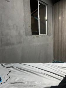a bed in a room with a window at Paradise in Natal