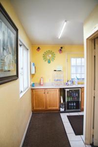 a kitchen with yellow walls and a counter top at The Perrysburg Budget Inn in Millbury