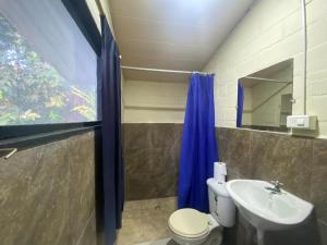 a bathroom with a toilet and a sink at Grand Selva Lodge & Tours in Tena +48 photos