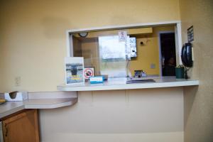 a bathroom counter with a sink and a mirror at The Perrysburg Budget Inn in Millbury