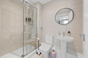 a bathroom with a toilet and a shower and a sink at Luxury 2BR Staines 12 Mins to Heathrow & Thames in Staines +12 photos