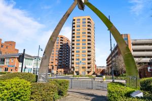 a tall building in the middle of a city at Luxury 2BR Staines 12 Mins to Heathrow & Thames in Staines
