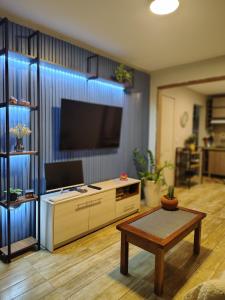 a living room with a tv and a coffee table at Chico's House in Uruguaiana