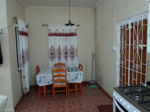 a dining room with a table and chairs in a kitchen at Vincy vybz in Kingstown