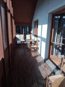 a porch with a table and chairs on a house at Wohnen mit Panoramablick in Gramastetten