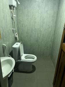 a bathroom with a toilet and a sink at Manta Ray in Fulidhoo