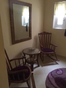 a room with two chairs and a table and a mirror at Fatah Apartment 14 in Luxor +4 photos