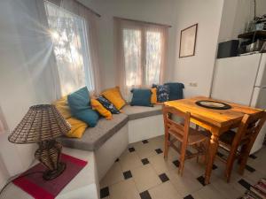 a living room with a couch and a table at Olive Grove House in Kámpos