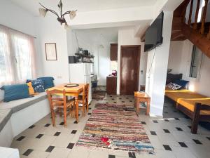 a living room with a table and a dining room at Olive Grove House in Kámpos