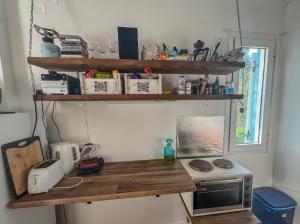 a kitchen with a wooden counter top with a microwave at Olive Grove House in Kámpos +22 photos