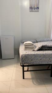 a room with a bed and a refrigerator at 586 Hotel in Toronto