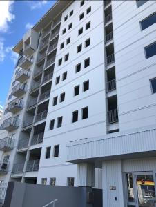 a white apartment building with balconies on it at Charming & Cozy Apartment in the Heart of Auckland - 2 bd-2 bth-free carpark in Auckland