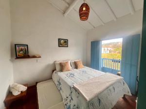 a bedroom with a bed and a large window at Casa Quintanilla Barichara in Barichara