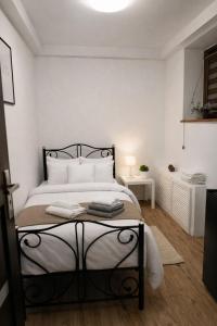 a bedroom with a large bed with white walls at 3 Rooms Garden Parking in Raszyn