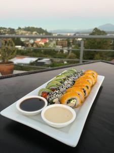 a plate of sushi on a table with a view at Dein Haus Hotel in Puerto Varas