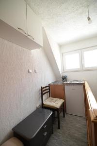 a kitchen with a table and a chair in a room at Planinski vuk rooms in Žabljak
