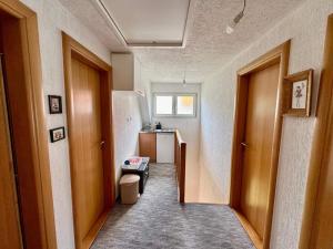 a hallway of a kitchen with a refrigerator at Planinski vuk rooms in Žabljak