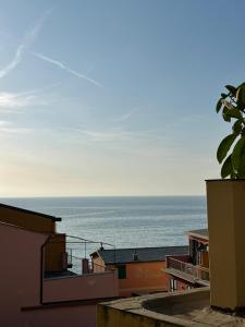 a view of the ocean from a building at Stylish & Colorful Open Space - Sleeps 5 in Manarola