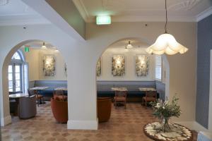 a restaurant with tables and chairs and a chandelier at No 9 Springfield in Sydney +44 photos