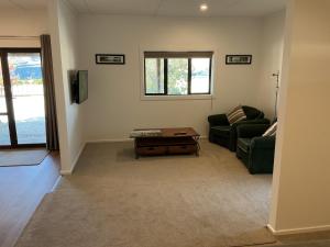 a living room with a couch and a coffee table at River and Mountain Central in Queensberry