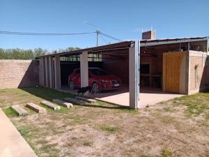 a car garage with a car parked in it at Mi casa es tu casa Loft in Malargüe
