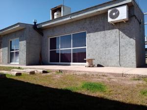 a building with a clock on the side of it at Mi casa es tu casa Loft in Malargüe