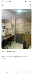 a picture of a kitchen with a table and a counter at Condominio Central Charmoso in Uruguaiana