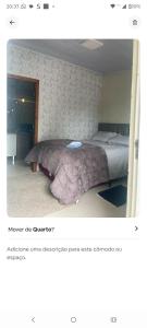 a picture of a bedroom with a bed in a room at Condominio Central Charmoso in Uruguaiana
