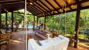 a porch with swinging chairs and a pool at DreamSpace Estate, Private Luxury Villa, Pool, Car and Beach in Nassau