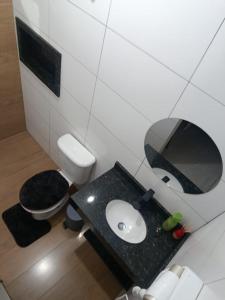 a small bathroom with a sink and a toilet at Espaço jr in Andradina +13 photos