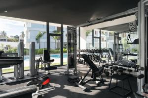 a gym with a lot of treadmills and machines at Sol de Arena Beachfront Condos by Bocobay in Las Terrenas