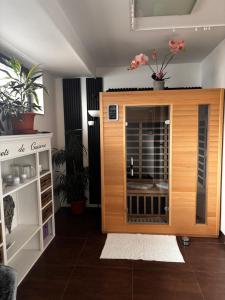 a room with a wooden enclosure with flowers on top at Apartmán NAVRCHU in Brezno