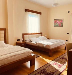 a bedroom with two beds and a window at Hotel Kanione in Çorovodë +95 photos